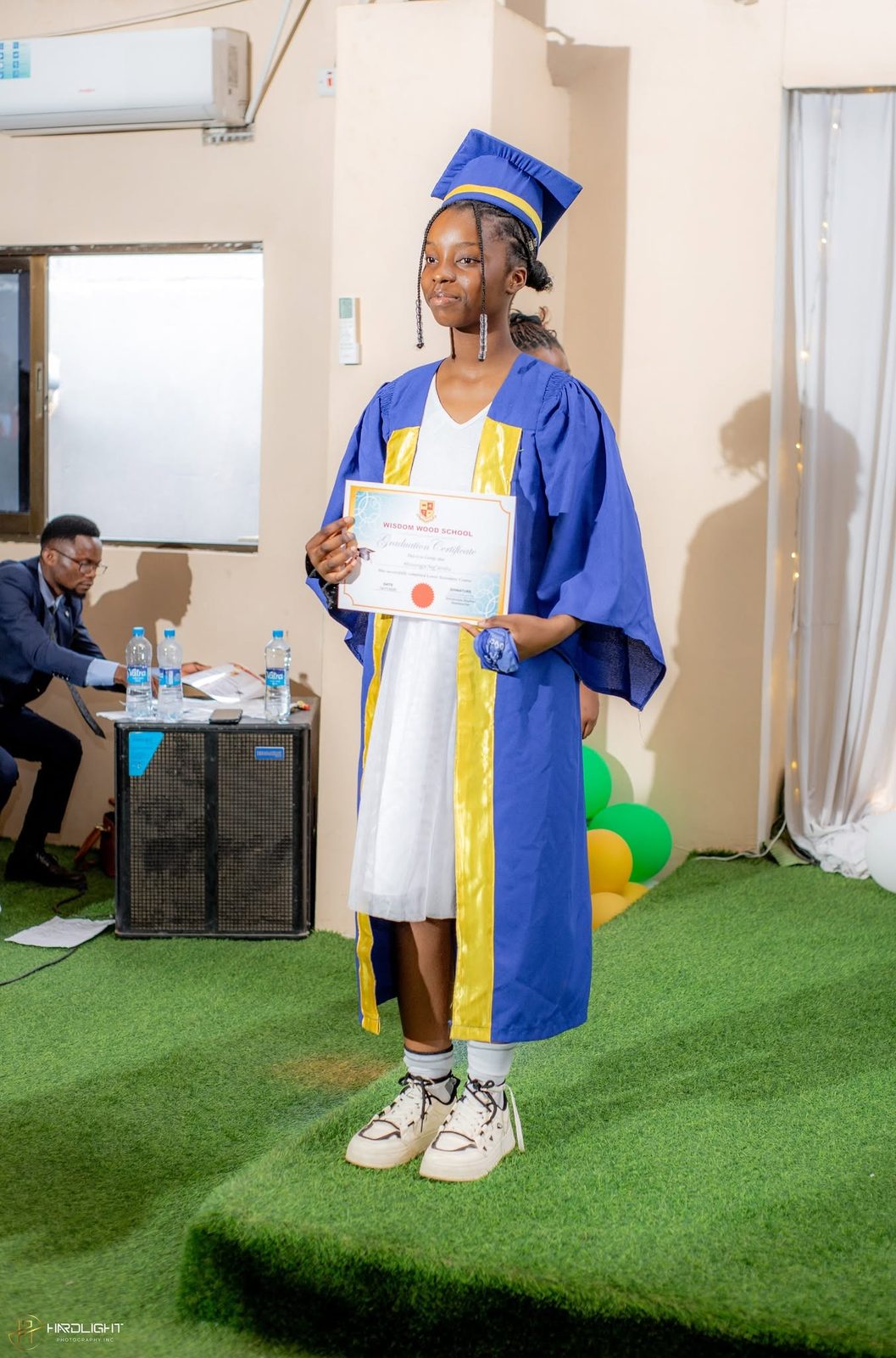 A graduate holding her certificate