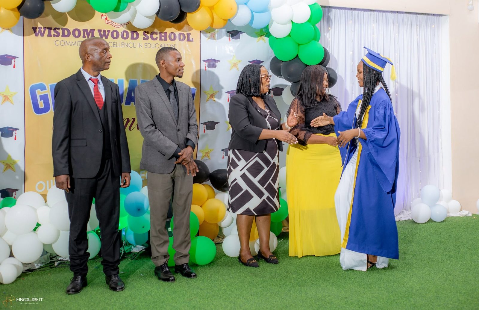 School leadership presenting a certificate on stage