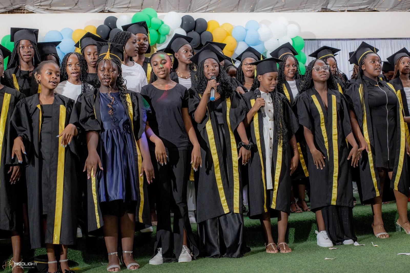 Graduates standing together in caps and gowns
